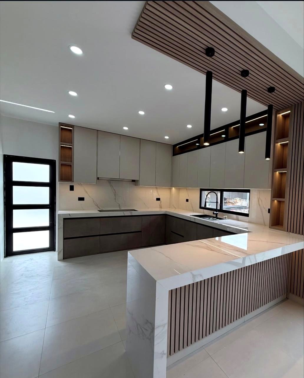 Custom contemporary kitchen with island by Oasis Interiors in the UAE