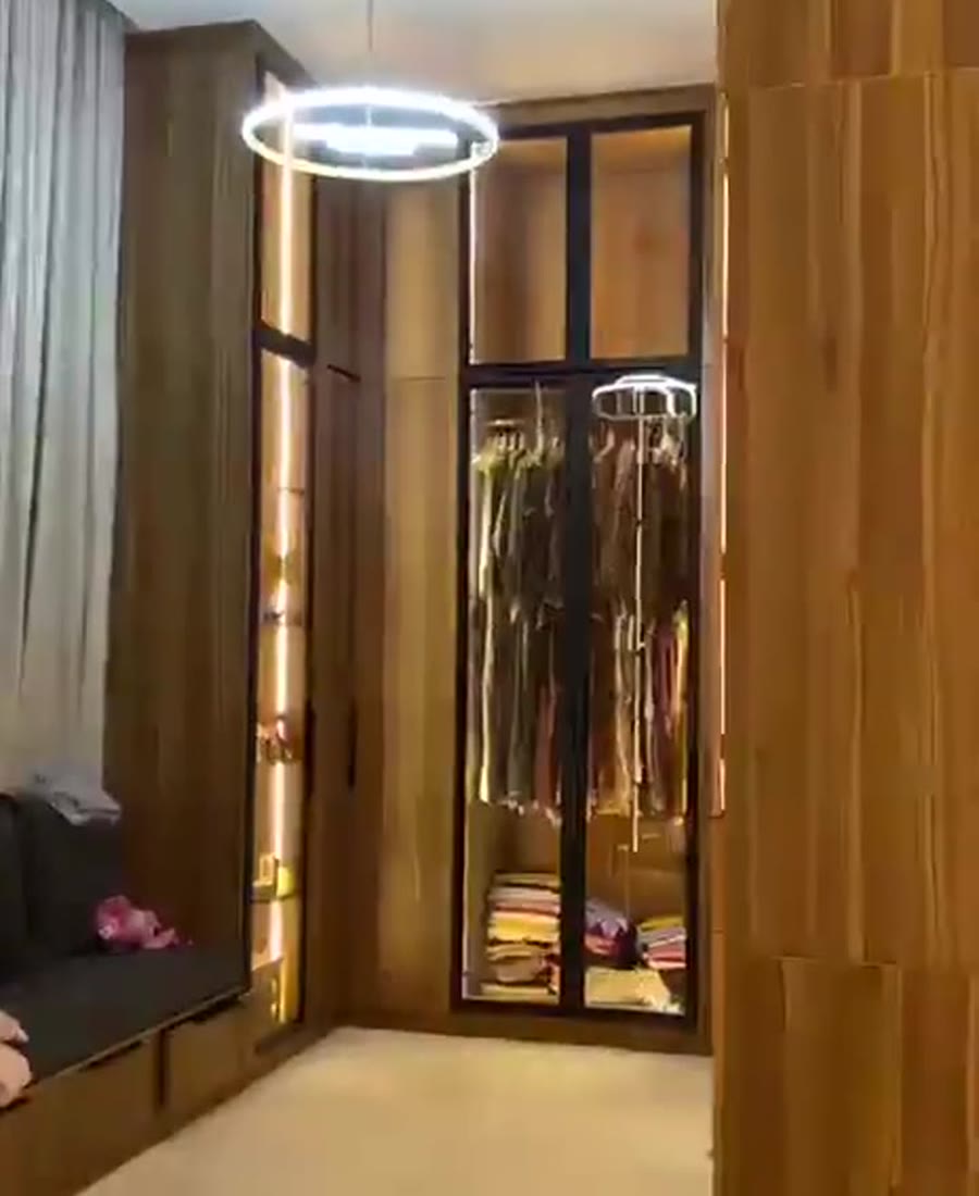 Custom fitted wardrobe with warm timber finish and integrated storage